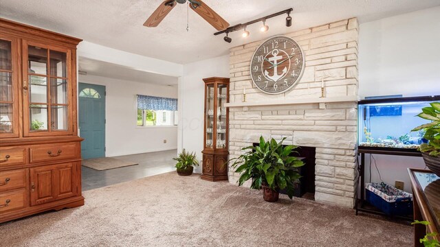 14672 Township Rd Unit 1062, Thornville, OH 43076 - living room with ceiling fan, a textured ceiling, carpet floors, and a fireplace