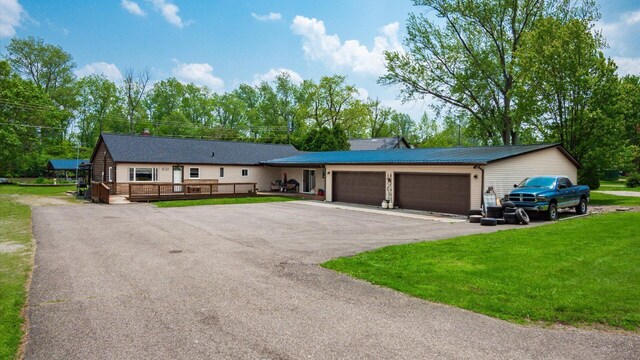 14672 Township Rd Unit 1062, Thornville, OH 43076 - single story home featuring a front lawn, asphalt driveway, a garage, and a wooden deck