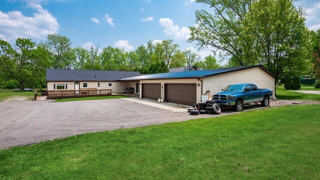 14672 Township Rd Unit 1062, Thornville, OH 43076 - single story home featuring a garage, a front lawn, driveway, and a wooden deck