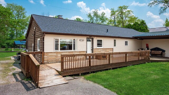 14672 Township Rd Unit 1062, Thornville, OH 43076 - rear view of property with a shingled roof, stone siding, a deck, and a yard