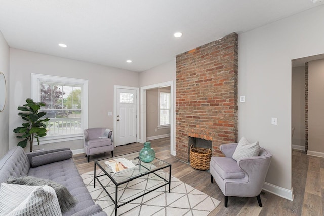 146 E Woodrow Ave, Columbus, OH 43207 - living room featuring plenty of natural light, baseboards, light wood finished floors, recessed lighting, and a brick fireplace