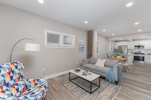 146 E Woodrow Ave, Columbus, OH 43207 - living room with light wood finished floors, recessed lighting, and baseboards