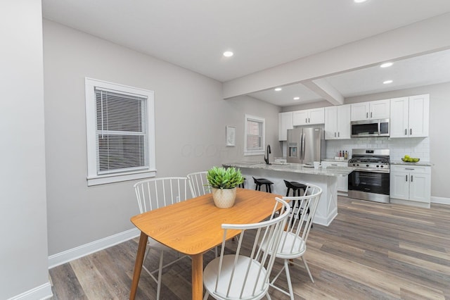 146 E Woodrow Ave, Columbus, OH 43207 - dining area with light wood-style flooring, recessed lighting, baseboards, and beamed ceiling