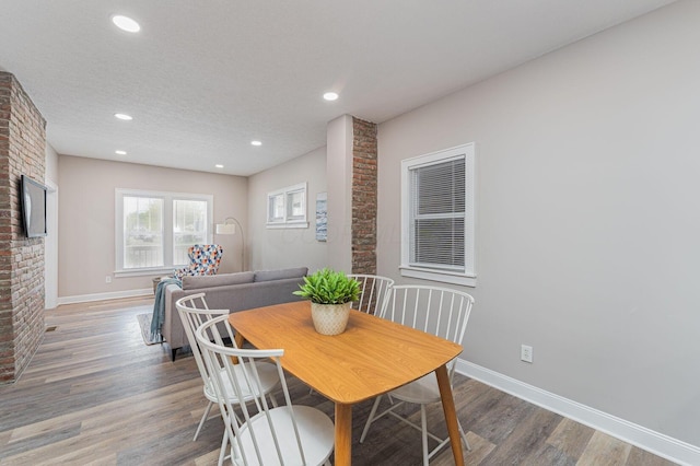 146 E Woodrow Ave, Columbus, OH 43207 - dining area with a fireplace, baseboards, wood finished floors, and recessed lighting
