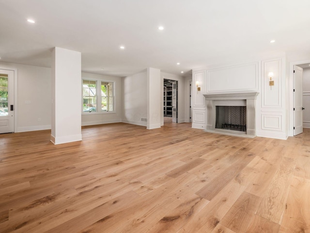 2355 Farleigh Rd, Columbus, OH 43221 - unfurnished living room with light wood-style floors, a fireplace with flush hearth, recessed lighting, and baseboards