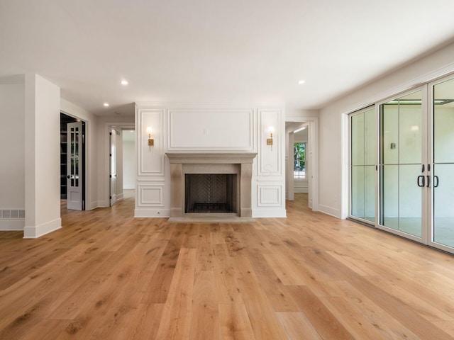 2355 Farleigh Rd, Columbus, OH 43221 - unfurnished living room with light wood-style flooring, baseboards, recessed lighting, and a fireplace