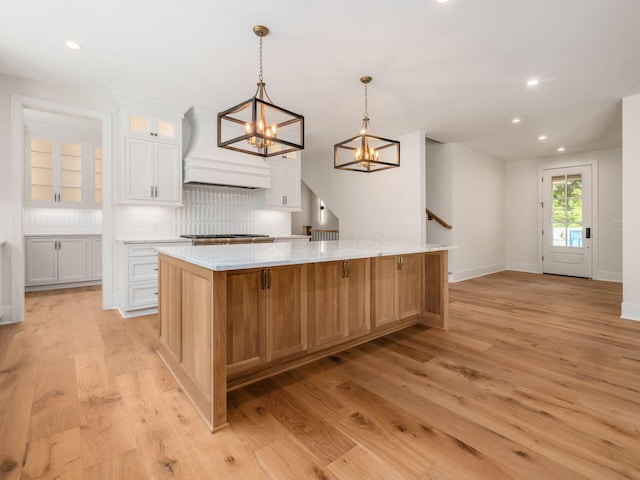 2355 Farleigh Rd, Columbus, OH 43221 - kitchen featuring a chandelier, light wood finished floors, recessed lighting, a spacious island, and white cabinets