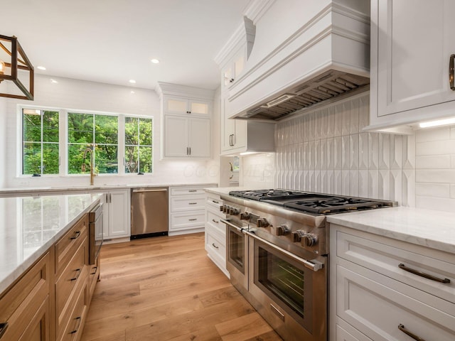 2355 Farleigh Rd, Columbus, OH 43221 - kitchen with stainless steel appliances, custom exhaust hood, white cabinetry, decorative backsplash, and recessed lighting
