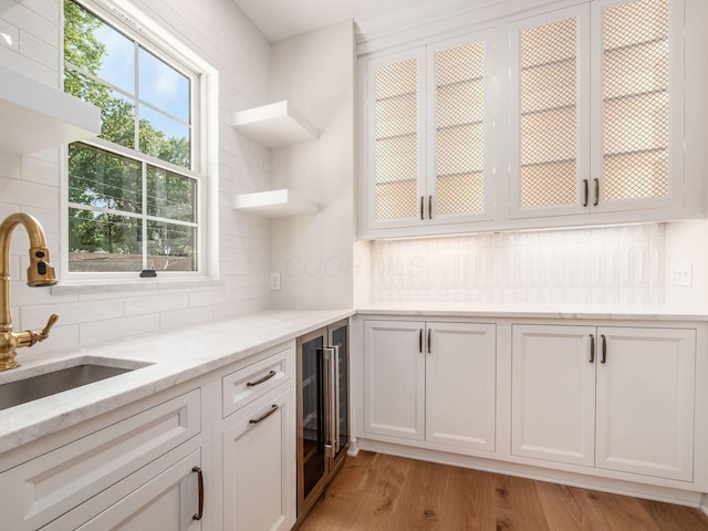 2355 Farleigh Rd, Columbus, OH 43221 - kitchen featuring a sink, beverage cooler, decorative backsplash, light stone counters, and white cabinetry