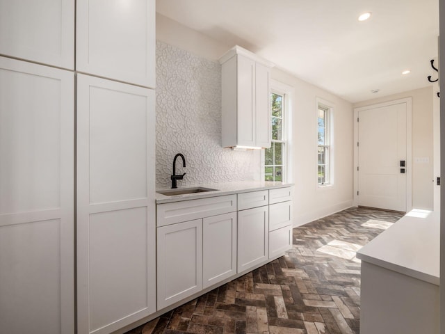 2355 Farleigh Rd, Columbus, OH 43221 - kitchen with a sink, white cabinetry, light countertops, recessed lighting, and brick flooring