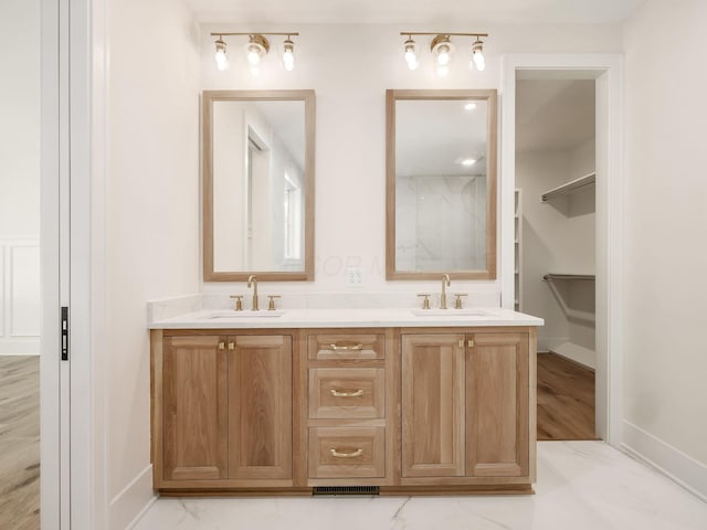 2355 Farleigh Rd, Columbus, OH 43221 - bathroom with baseboards, double vanity, and marble look tiles