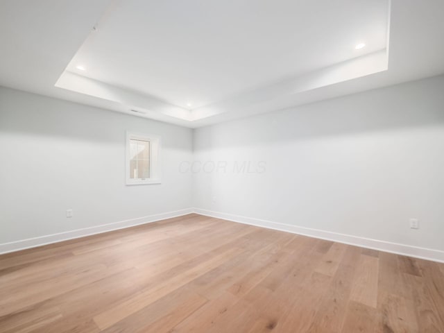 2355 Farleigh Rd, Columbus, OH 43221 - spare room with a tray ceiling, baseboards, light wood-type flooring, and recessed lighting