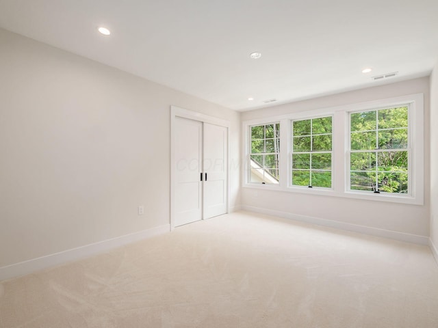 2355 Farleigh Rd, Columbus, OH 43221 - unfurnished bedroom featuring baseboards, multiple windows, light colored carpet, and recessed lighting
