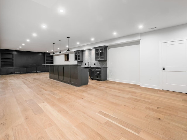 2355 Farleigh Rd, Columbus, OH 43221 - kitchen with recessed lighting, light wood finished floors, a kitchen island, glass insert cabinets, and a sink