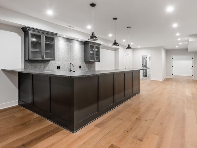 2355 Farleigh Rd, Columbus, OH 43221 - kitchen featuring tasteful backsplash, glass insert cabinets, recessed lighting, and light wood-style floors