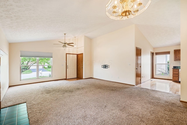 4977 Softwood Ct, Westerville, OH 43081 - unfurnished living room with carpet flooring, vaulted ceiling, a chandelier, baseboards, and a ceiling fan