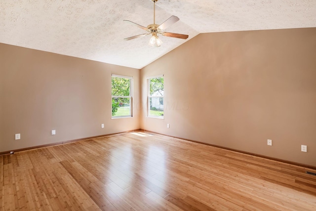 4977 Softwood Ct, Westerville, OH 43081 - empty room with a ceiling fan, a textured ceiling, lofted ceiling, light wood finished floors, and baseboards