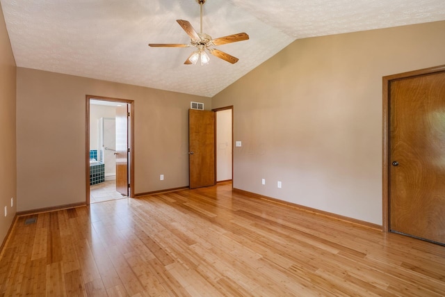 4977 Softwood Ct, Westerville, OH 43081 - empty room featuring vaulted ceiling, light wood finished floors, ceiling fan, baseboards, and a textured ceiling