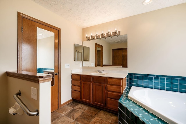 4977 Softwood Ct, Westerville, OH 43081 - full bath with a garden tub, a textured ceiling, vanity, and baseboards