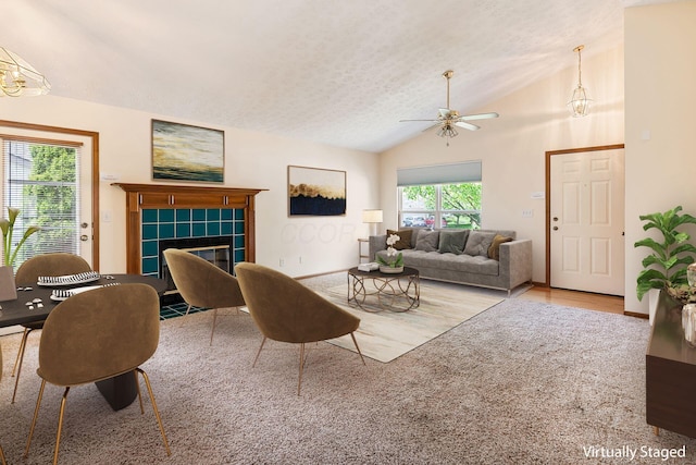 4977 Softwood Ct, Westerville, OH 43081 - living room with a fireplace, ceiling fan, vaulted ceiling, a textured ceiling, and wood finished floors