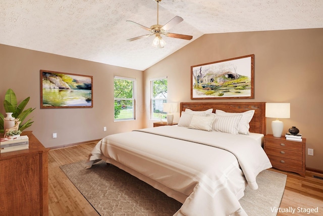 4977 Softwood Ct, Westerville, OH 43081 - bedroom featuring light wood finished floors, lofted ceiling, baseboards, a textured ceiling, and ceiling fan