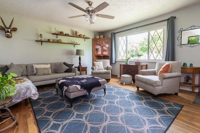 109 Williams Rd, Columbus, OH 43207 - living room featuring ceiling fan, wood finished floors, and a textured ceiling