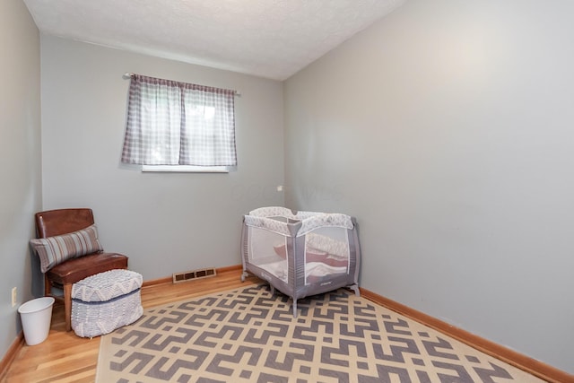 109 Williams Rd, Columbus, OH 43207 - sitting room with wood finished floors, baseboards, and a textured ceiling