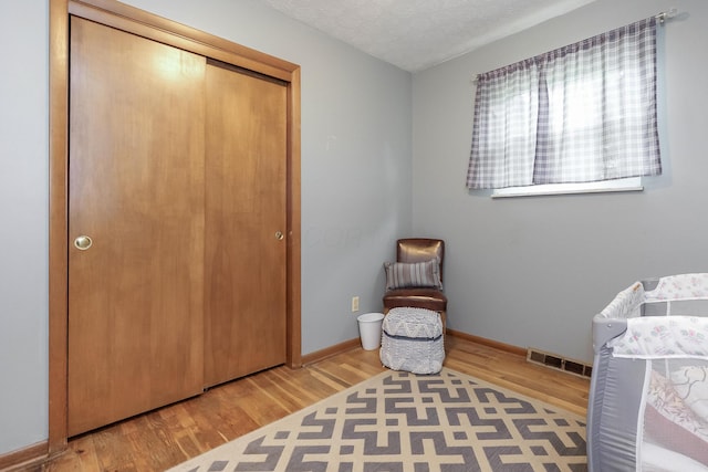 109 Williams Rd, Columbus, OH 43207 - bedroom featuring wood finished floors, a closet, baseboards, and a textured ceiling