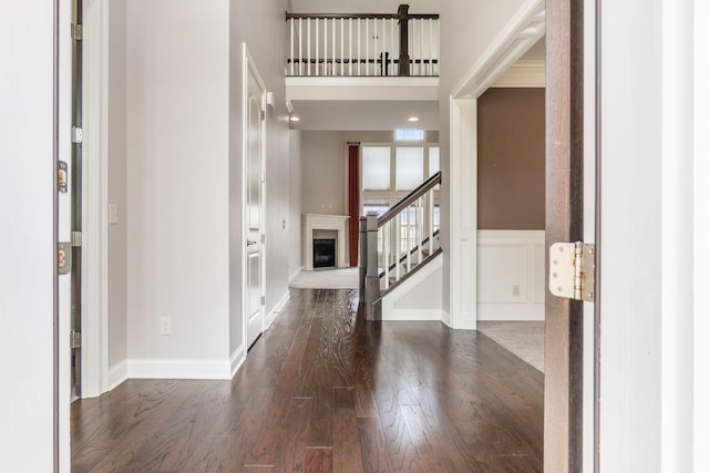 1393 Kearney Way, Delaware, OH 43015 - entryway featuring dark wood-style flooring, stairs, a fireplace with raised hearth, and baseboards