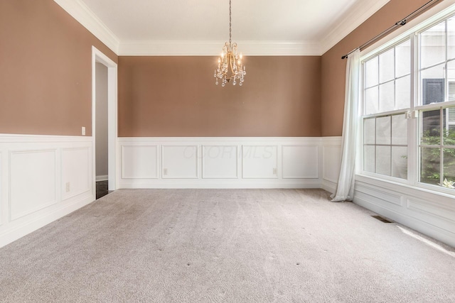 1393 Kearney Way, Delaware, OH 43015 - carpeted spare room featuring a chandelier, healthy amount of natural light, a decorative wall, a wainscoted wall, and crown molding