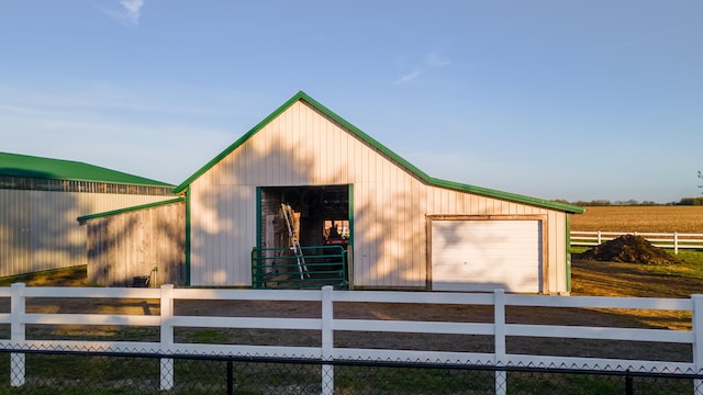 view of outdoor structure with an outdoor structure, dirt driveway, an exterior structure, and a rural view