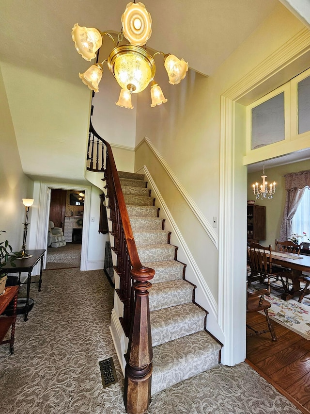 3851 Snow Hill Rd SW, Washington Court House, OH 43160 - stairs featuring a chandelier, baseboards, and carpet floors