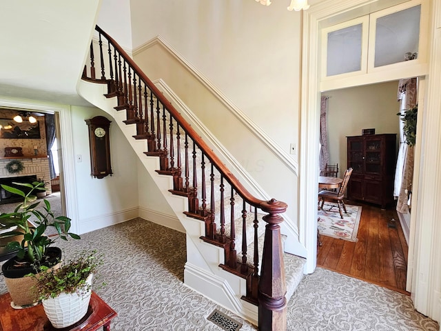 3851 Snow Hill Rd SW, Washington Court House, OH 43160 - staircase featuring a towering ceiling and a fireplace