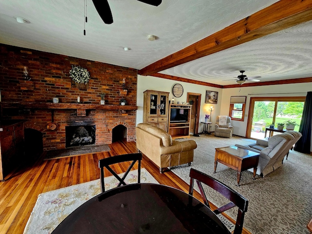 3851 Snow Hill Rd SW, Washington Court House, OH 43160 - living room featuring ceiling fan, wood-type flooring, a fireplace, and beamed ceiling