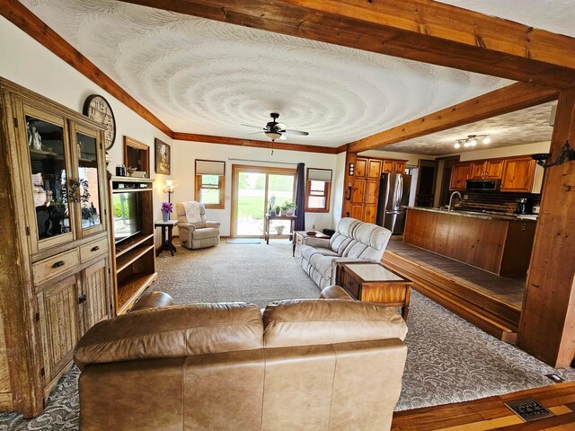 3851 Snow Hill Rd SW, Washington Court House, OH 43160 - living room featuring carpet flooring, ceiling fan, beam ceiling, and crown molding