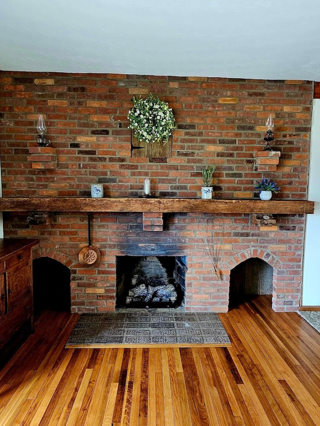 3851 Snow Hill Rd SW, Washington Court House, OH 43160 - unfurnished living room featuring hardwood / wood-style floors and a brick fireplace