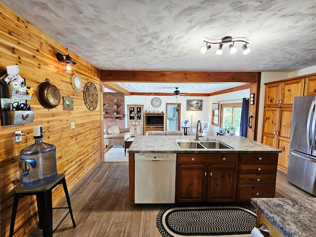 3851 Snow Hill Rd SW, Washington Court House, OH 43160 - kitchen featuring dishwashing machine, freestanding refrigerator, a sink, dark wood-style floors, and wooden walls