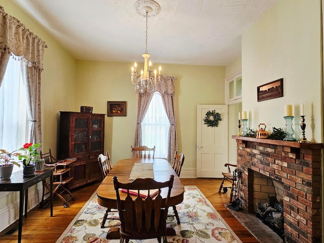 3851 Snow Hill Rd SW, Washington Court House, OH 43160 - dining space featuring plenty of natural light, a chandelier, dark wood-type flooring, and a fireplace