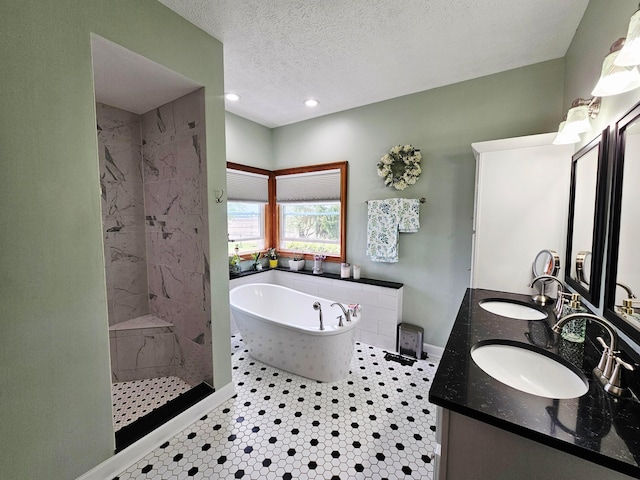 3851 Snow Hill Rd SW, Washington Court House, OH 43160 - full bath with a tub to relax in, a tile shower, a textured ceiling, double vanity, and baseboards