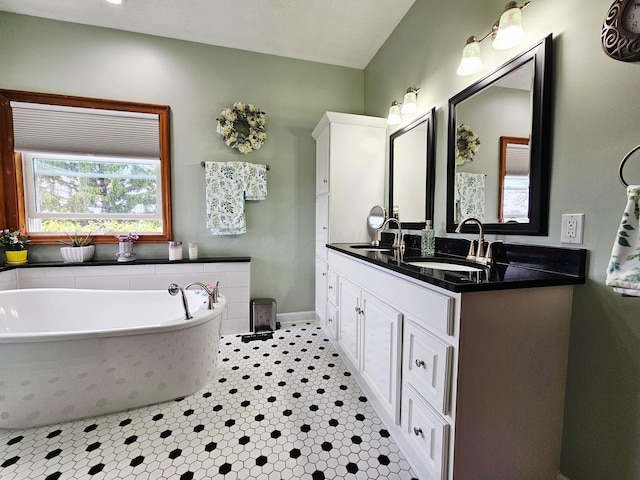 3851 Snow Hill Rd SW, Washington Court House, OH 43160 - full bath featuring double vanity, a garden tub, and baseboards