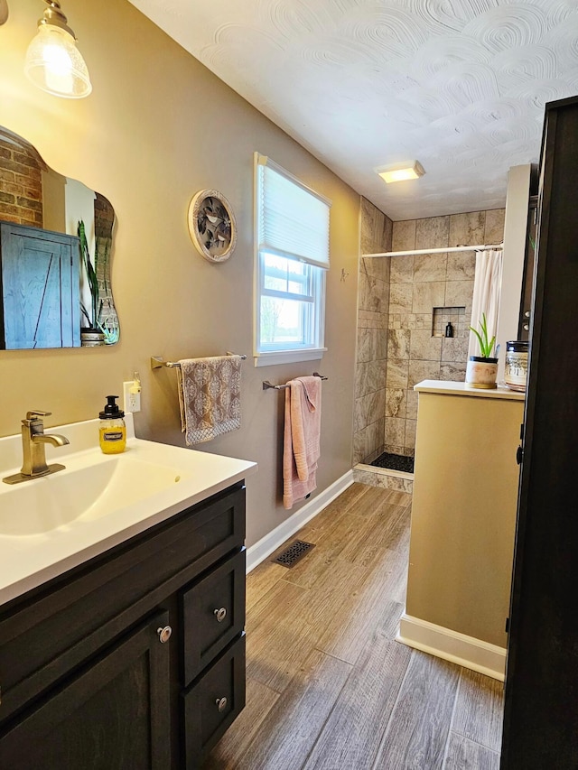 3851 Snow Hill Rd SW, Washington Court House, OH 43160 - full bath with tiled shower, vanity, wood finished floors, and baseboards