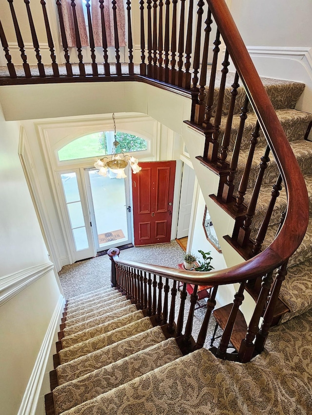 3851 Snow Hill Rd SW, Washington Court House, OH 43160 - stairs featuring a chandelier, carpet flooring, and healthy amount of natural light
