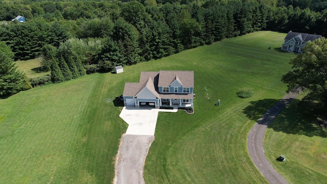 birds eye view of property featuring a wooded view