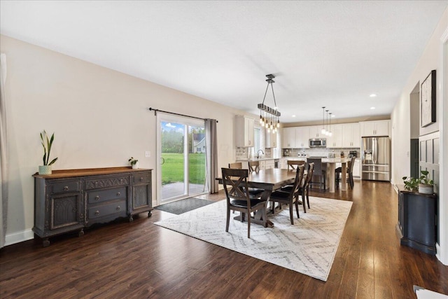 dining room featuring dark wood-style floors, recessed lighting, and a chandelier