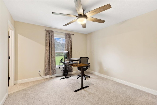 carpeted home office with baseboards and a ceiling fan