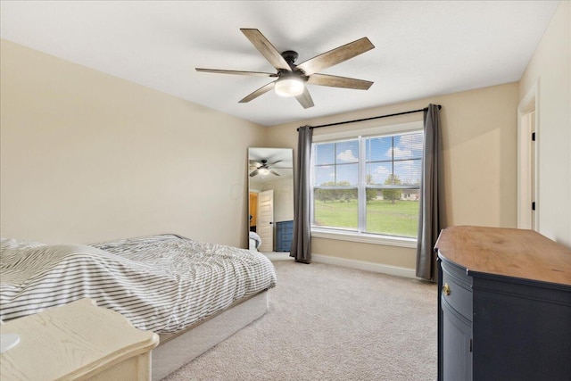 bedroom with baseboards, light colored carpet, and ceiling fan