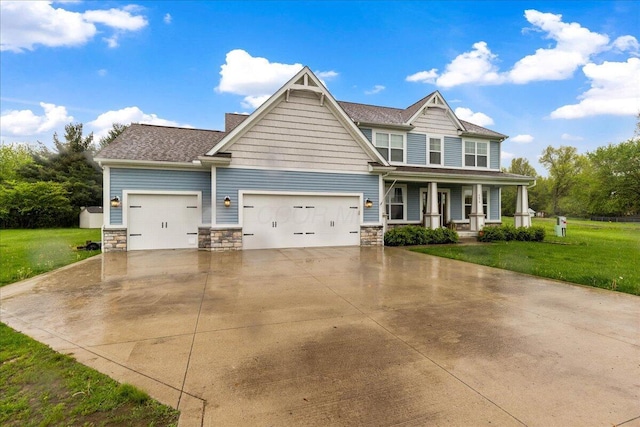 craftsman house featuring a porch, an attached garage, concrete driveway, a front lawn, and stone siding