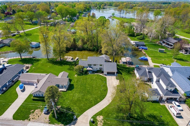 drone / aerial view featuring a water view and a residential view