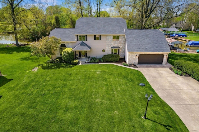 view of front of home with a garage, a front lawn, and stone siding