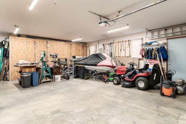 garage with a workshop area and a garage door opener
